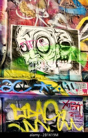 Verrückt aussehendes Plakat auf der farbenfrohen, mit Graffiti gefüllten Ziegelwand, Hosier Street, Melbourne Lanes, Melbourne, Victoria, Australien Stockfoto
