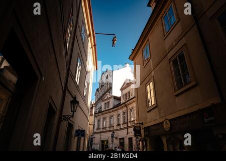 Prag, Tschechien - 10.08.2019. Die Architektur der Prager Altstadt. Alte Gebäude, gemütliche Straßen. Mann hängend aus, ein Kunstwerk von David Cerny Stockfoto