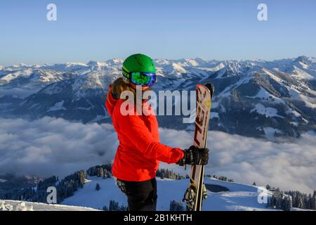 Skifahrer mit Skihelm und Skiständen vor dem Bergpanorama, Blick in die Kamera, SkiWelt Wilder Kaiser, Brixen im Thale, Tyrol, Österreich Stockfoto