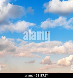 Das Seil eines Bauladungskrans auf blauem Himmel mit Wolken. Stockfoto