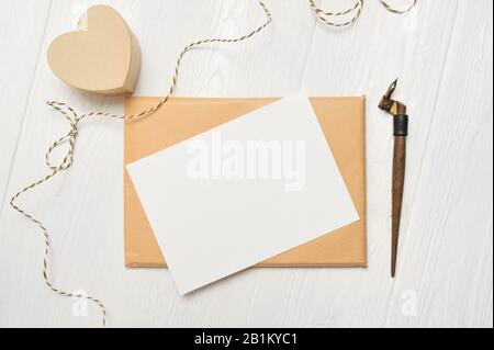 Mockup Letter mit einer Grußkarte aus Kalligraphien zum Valentinstag oder zur Hochzeit im rustikalen Stil mit Platz für Ihren Text. Flache Lage, Draufsicht Stockfoto