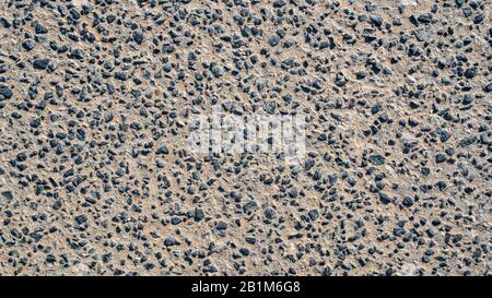 Hintergrundbild mit kleinem Stein aus Granit und Sand einer Straße. Stockfoto
