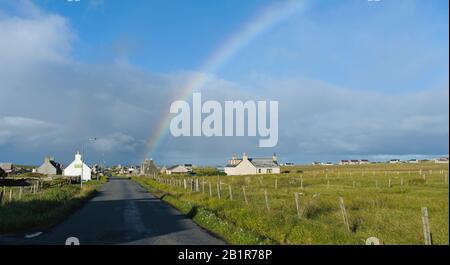 Ein Regenbogen über der abgelegenen Kropfgemeinde Habost, Port of Ness auf der Insel Lewis, Schottland Stockfoto