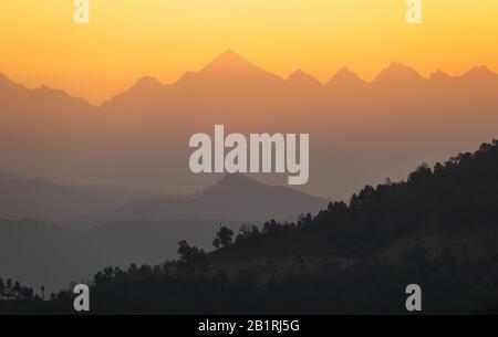 Das orange Licht der Morgensonne trifft die Panchachuli-Gipfel in der Himalaya-Stadt Munsyari in Uttarakhand. Stockfoto