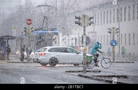 27. Februar 2020, Bayern, München: Ein Radfahrer überquert bei starkem Schneefall eine Kreuzung. Foto: Sven Hoppe / dpa Stockfoto