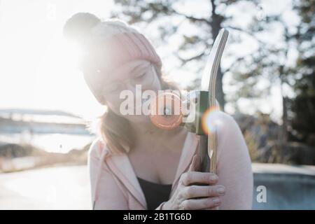 Skateboard Rad in der Sonne mit Frau im Hintergrund Stockfoto