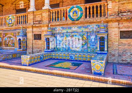 Sevilla, SPANIEN - 1. OKTOBER 2019: Die schönen Bänke auf der Plaza de Espana mit bunten Azulejos (Keramikfliesen), die verschiedene Spani darstellen Stockfoto