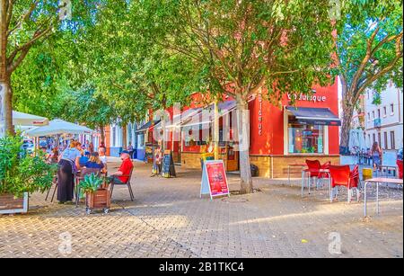 Sevilla, SPANIEN - 1. OKTOBER 2019: Das Café im Freien auf dem La Alameda-Platz unter dem Schatten der Pappelbäume ist der perfekte Ort für die Abendruhe. Stockfoto