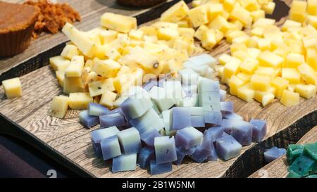 Verschiedene Käsesorten auf natürlichem Holztisch Stockfoto