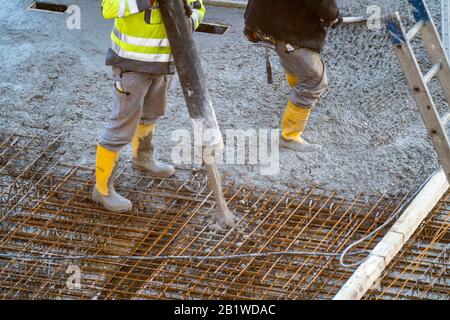 Baustelle, Betonierung, Boden, Decke für ein Gebäude wird betoniert, der Beton auf die Stahlbetonmatten gepumpt, Stockfoto