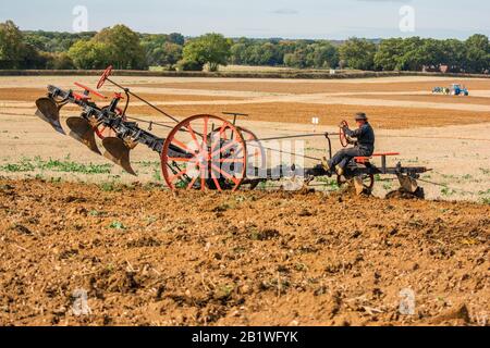 Alter Alter Traktor - Anbaugerätezug - 1900-er-er-Streammotorpflug mit Pflügen auf einem Feld in Oxfordshire Berkshire England Großbritannien Stockfoto