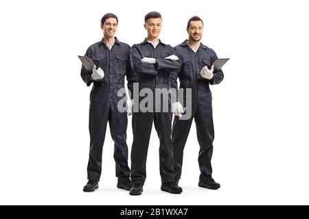 Porträt von drei Mechanikern in Uniformen, isoliert auf weißem Hintergrund Stockfoto