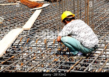 Arbeiter in der Baustelle, die Verstärkung aus Metall Rahmen für Beton gießt Stockfoto