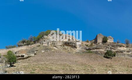 Blick auf die Höhlenstadt-Festung Chufut-Kale vom Südhang und den Balken Maryam-Dere. Ein warmer Sonnentag Stockfoto