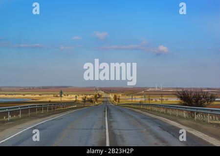Die Straße in die Ferne über die Hügel des Taman-Peninsula-Wintertags. Warmer schneeloser Winter. Stockfoto