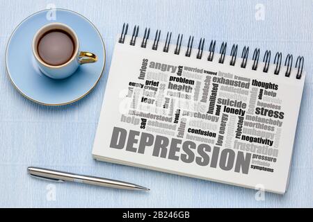 Depressionswortwolke in einem Skizzenbuch mit einer Tasse Kaffee, Wohlbefinden und einem Konzept für psychische Gesundheit Stockfoto