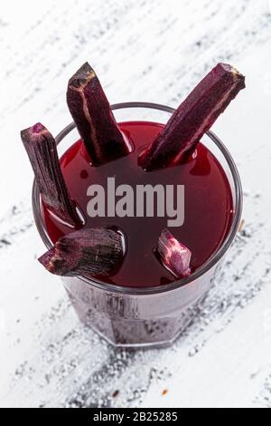 Traditioneller türkischer Getränkesaft (Salgam). Roter Karotten- und Rüssensaft auf weißem Holzhintergrund. Stockfoto