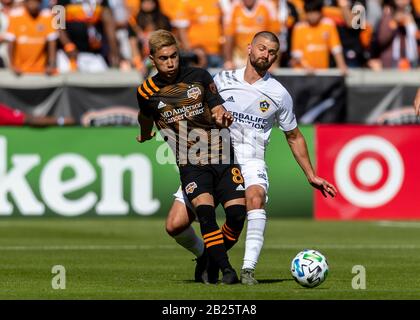 Houston, Texas, USA. Februar 2020. Houston Dynamo-Mittelfeldspieler Memo Rodriguez (8) und Los Angeles Galaxy-Verteidiger Perry Kitchen (2) kämpfen während des Spiels im BBVA Stadium in Houston, Texas um den Ball. Maria Lysaker/CSM/Alamy Live News Stockfoto