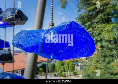 Ein zerbrochener Glasstein, der an einem Stahlkabel aufgehängt ist Stockfoto