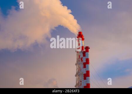 Smokestacks gegen einen klaren blauen Himmel. Umweltfragen und das Konzept der globalen Erwärmung Stockfoto