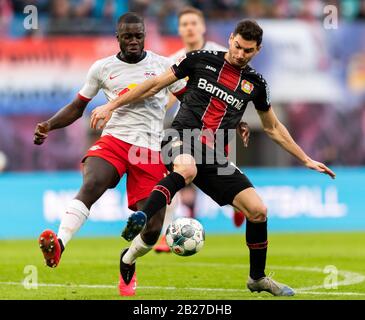 Leipzig, Deutschland. März 2020. Fußball: Bundesliga, RB Leipzig - Bayer 04 Leverkusen, 24. Spieltag, in der Red Bull Arena. Leipzig Dayot Upamecano (l) gegen Leverkusens Lucas Alario. Kredit: Robert Michael / dpa-Zentralbild / dpa - WICHTIGER HINWEIS: Gemäß den Vorschriften der DFL Deutsche Fußball Liga und des DFB Deutscher Fußball-Bund ist es untersagt, im Stadion und/oder aus dem fotografierten Spiel in Form von Sequenzbildern und/oder videoähnlichen Fotoserien auszunutzen oder auszunutzen./dpa/Alamy Live News Stockfoto