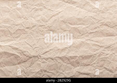 Zerknitterte Papierhintergrundstruktur. Brauner Papierhintergrund Stockfoto