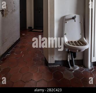 Treppenhaus in einem alten Apartmentgebäude in Paris. Gemeinsames Waschbecken und antike Buntglasfenster. Abgebrochener Zustand. Frankreich Stockfoto