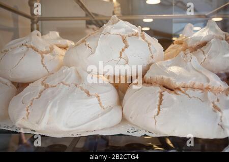 Portugiesische Suspiros-Gebäckstücke werden im Laden angeboten. Traditionelles Dessert, das im Allgemeinen als Meringues bekannt ist Stockfoto