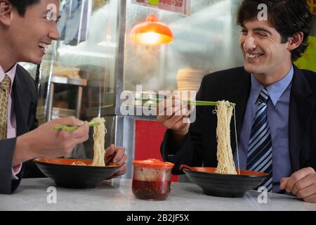 Zwei Geschäftsleute essen in der chinesischen Bar Stockfoto