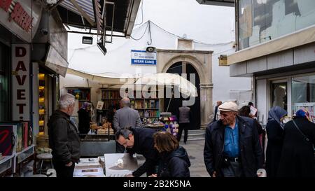 Kemeralti, Konak, Izmir/Türkei - 03/01/2020: Menschen kaufen in engen Gassen ein und ruhen in kleinen Cafés. Blick auf die Straßen rund um die Hisar-Moschee. Stockfoto