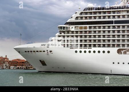 Das riesige Kreuzfahrtschiff MSC Musica dominiert am Abend die Skyline von Venedig, italien. Stockfoto