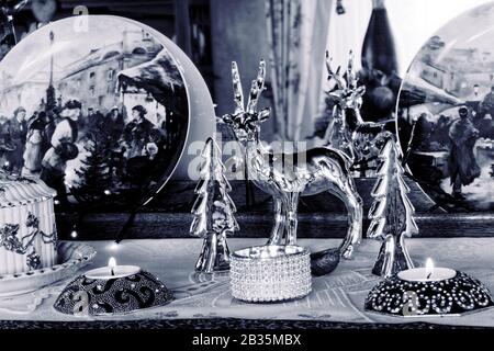 Weihnachts-Stillleben - Zimmerdekoration in Blau: Christmassy Zimmerdekoration Stillleben mit silberfarbenem Zierhirsch, Weihnachtsbäumen, Teekerze Stockfoto