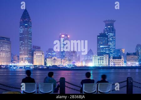 Shanghai, China - Menschen, die von Pudong aus die Skyline des Bundes über den Fluss Huangpu beobachten. Stockfoto