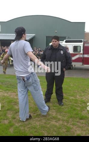 Cedar Park, Texas 07 MAR 2001: Eine von Studenten geführte Produktion von „Shattered Dreams“ mit dem simulierten Drama eines Teenagerunfalls, der im Rausch war (DUI), komplett mit Polizisten, Krankenwagen, medizinischem Evakuierungshubschrauber und einem Leichenwagen, wurde an der Cedar Park High School inszeniert, um Schülern zu helfen, nicht zu trinken und zu fahren. An der Produktion nahmen Dutzende von Studenten als Unfallopfer, Berater und weinende Verwandte Teil, darunter eine Beerdigungs-Produktion mit Schatullen und trauernden Eltern. Hier' führt ein verdächtiger betrunkener Fahrer einen nüchternen Feldtest für einen Polizisten durch. HERR SV-0 ©Bob Daemmrich Stockfoto