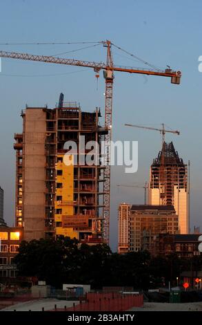 Austin, Texas USA, 21. Juli 2003: Die Skyline der Innenstadt am Abend von der Ecke 6th und Lamar Blvd. Zeigt Neubau mit den Austin City Lofts im Vordergrund und dem neuen Convention Center Hilton Hotel im Hintergrund. Austin wächst trotz der schleppenden US-Wirtschaft immer noch. ©Bob Daemmrich Stockfoto