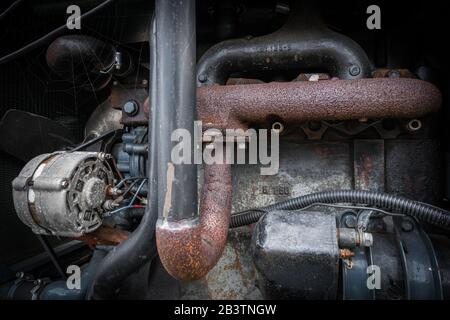 Ein Blick auf einen alten Traktormotor mit Spinnennetz. Stockfoto