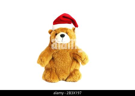 Kinderspielzeug Teddybär in rotem Weihnachtsmann Hut. Auf weißem Hintergrund isolieren. Stockfoto