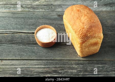 Brot und Salz auf einem Holztisch Stockfoto