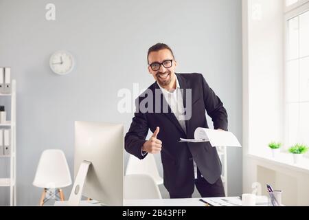 Handshake-Angebot. Ein Geschäftsmann bietet einen Handschlag, während er in einem Büro steht. Stockfoto