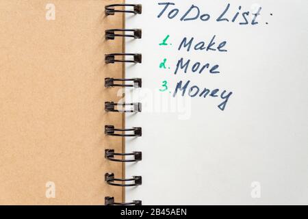 To-DO-Liste - verdienen Sie mehr Geld, wenn Sie Text auf dem Notizblock schreiben. Nahaufnahme. Stockfoto