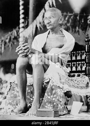 Mahatma Gandhi sitzt auf einem handgefertigten Stuhl, Indien, 1930, altes Vintage 1900er Bild Stockfoto