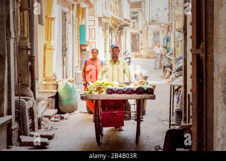 Ahmedabad/Indien/11. April 2017: Indianischer Mann, der Früchte auf den belebten Straßen Indiens trägt Stockfoto