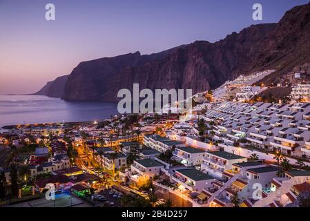 Spanien, Kanarische Inseln, Teneriffa, Los Gigantes, Hillside Apartments und Steilküsten, Erhöhte Ansicht, Dämmerung Stockfoto