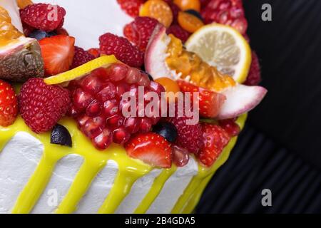 Leckerer, gelber Obstkuchen aus nächster Nähe zum Geburtstag. Auf dunklem Hintergrund. Stockfoto