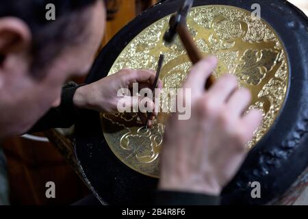 Man Gravurmuster auf Metallplatte, Buchara, Usbekistan Stockfoto