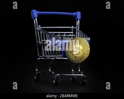 Warenkorb mit Goldbitcoin auf der Vorderseite isoliert auf schwarzem Hintergrund Stockfoto