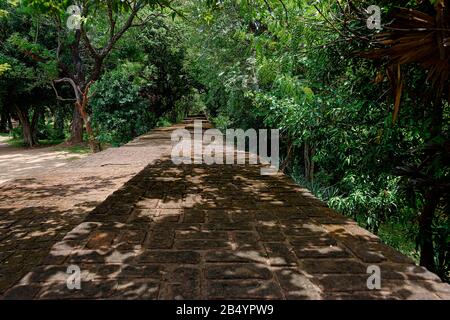 Polonnaruwa, Sri lanka, Sept. 2015: Diese Steinmauern rund um den Ort der Ruinen bei Polonnaruwa sind heute beschattete Wege für Touristen Stockfoto