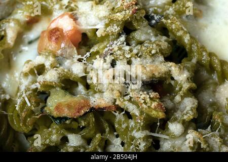 Makro-Nahaufnahme von glutenfreiem Kasserol (Pasta al Forno) mit Gemüse und Käse. Stockfoto