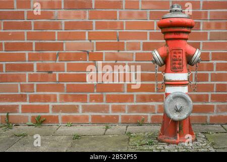 Brandhydrant vor einer Wand. Stockfoto