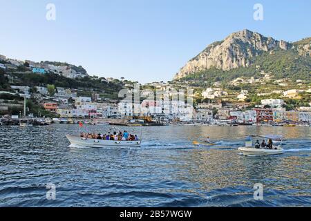Ausflugsboote, die Marina Grande auf der Insel Capri verlassen. Diese ersten Touren am Morgen sorgen für den Transport der Bootsleute. Stockfoto